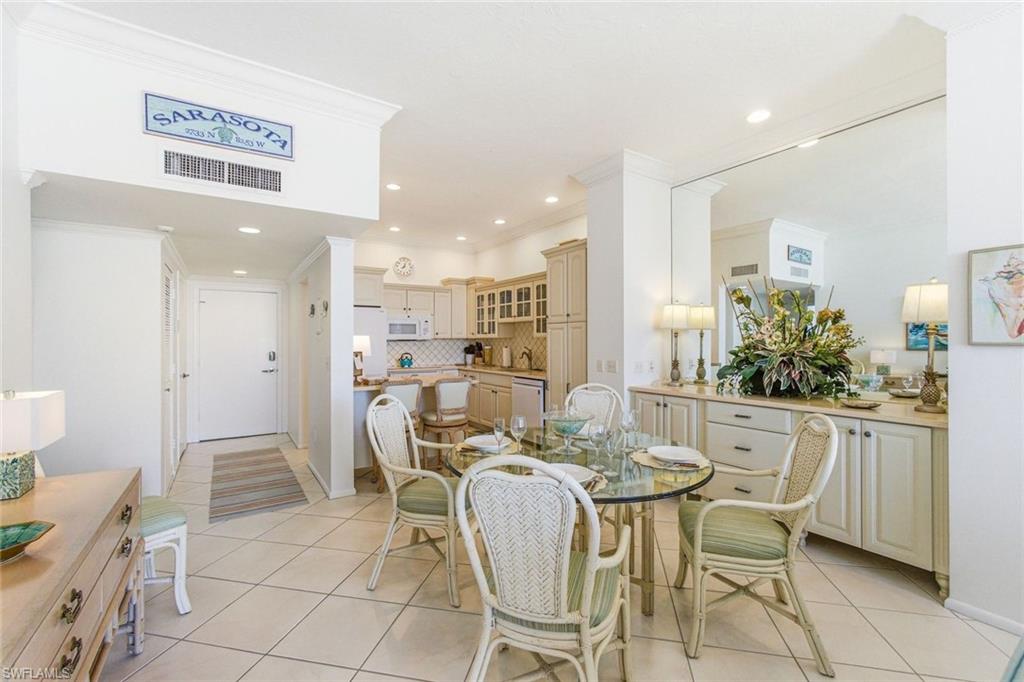 Dining room with crown molding, light tile patterned floors, and recessed lighting