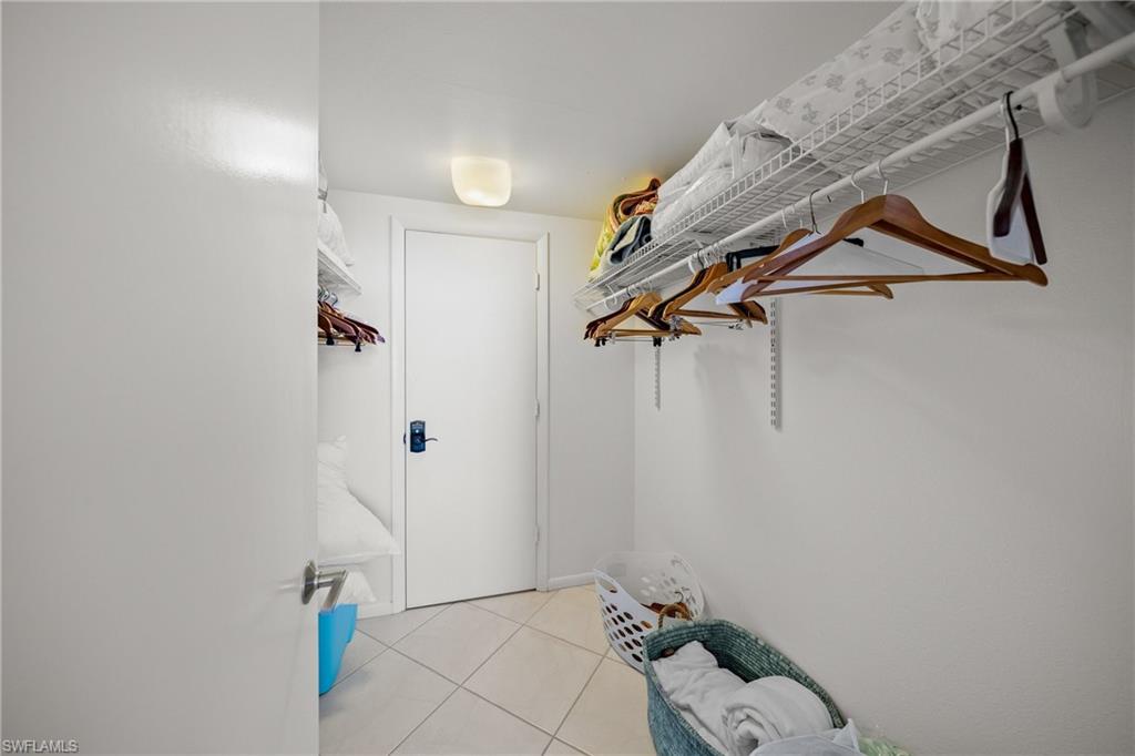 Spacious walk in closet with keypad owner's closet extra storage beyond condo community offerings.