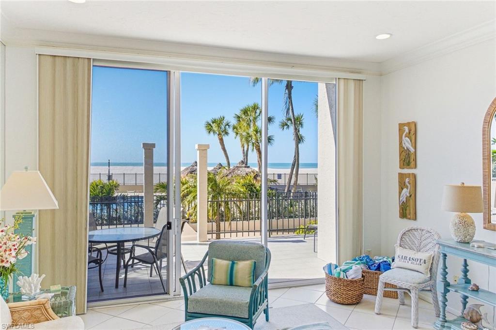Living area with crown molding, a water view, tile patterned flooring, and recessed lighting