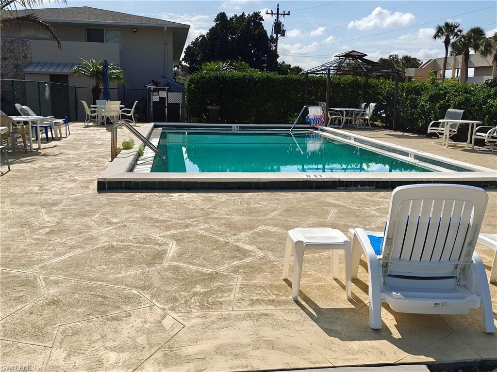 View of swimming pool featuring a gazebo and a patio