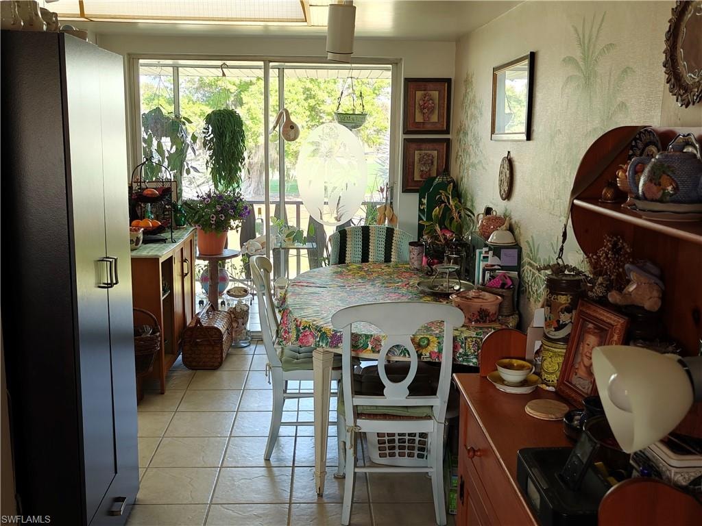 Dining space with light tile patterned flooring