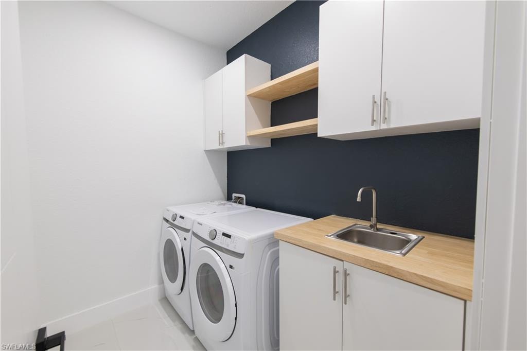 Laundry room featuring cabinet space and washer and dryer