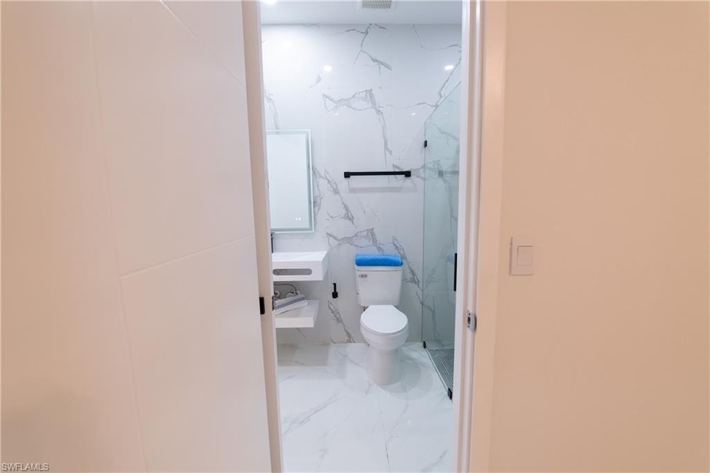Bathroom featuring toilet and a shower