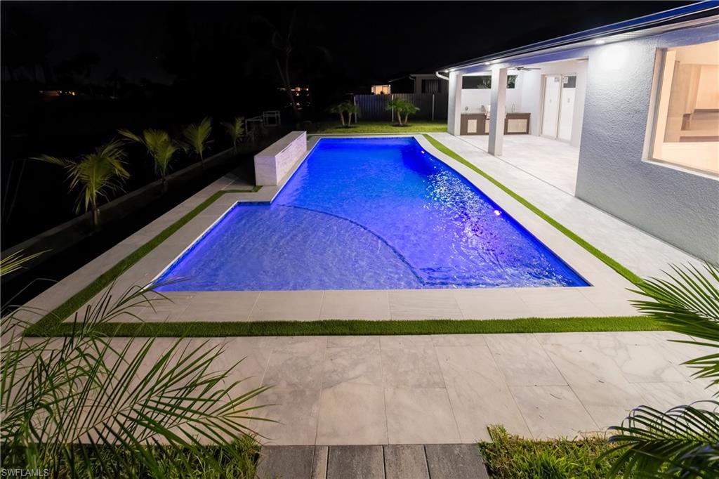 Pool at twilight with a patio