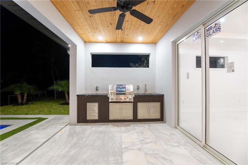 View of patio / terrace featuring area for grilling, sink, and ceiling fan