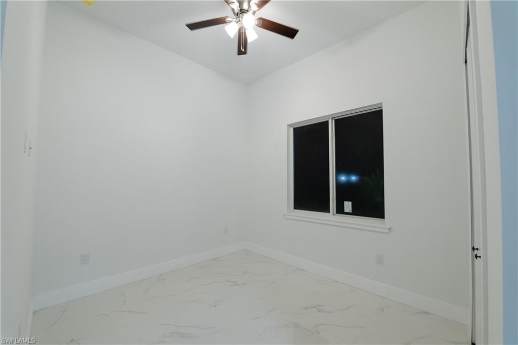 Empty room featuring ceiling fan