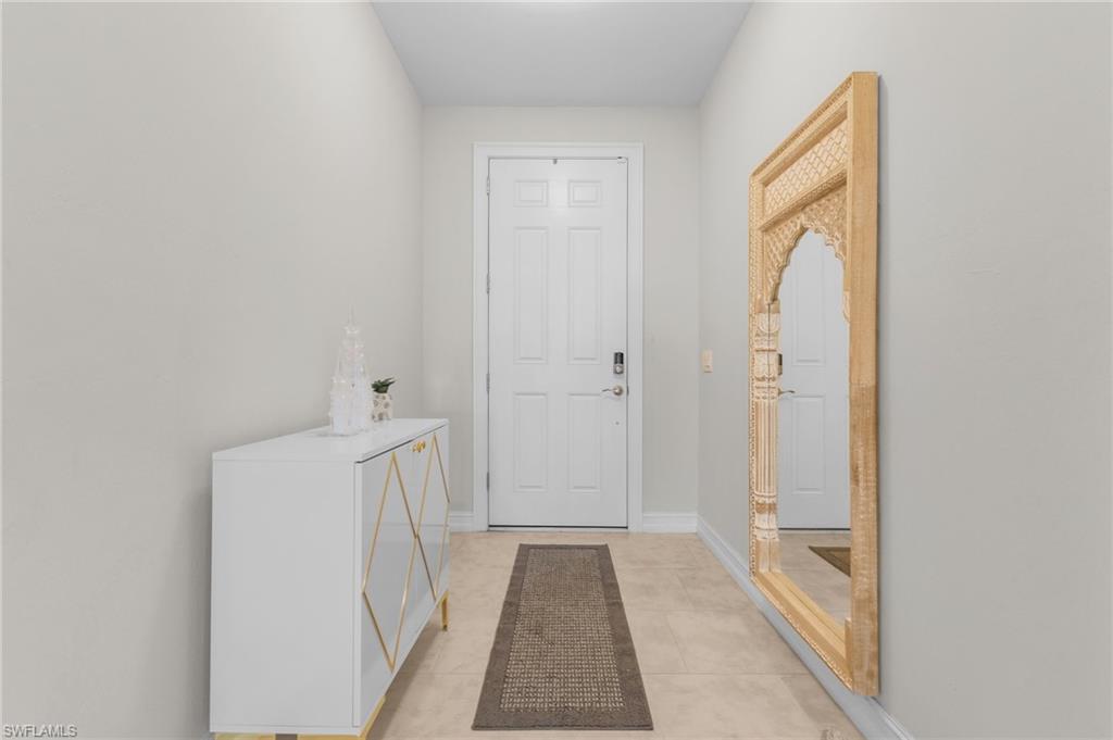 Doorway with light tile patterned floors