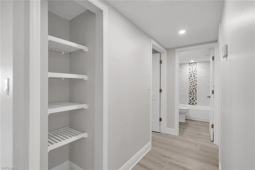 Hall featuring light wood-type flooring