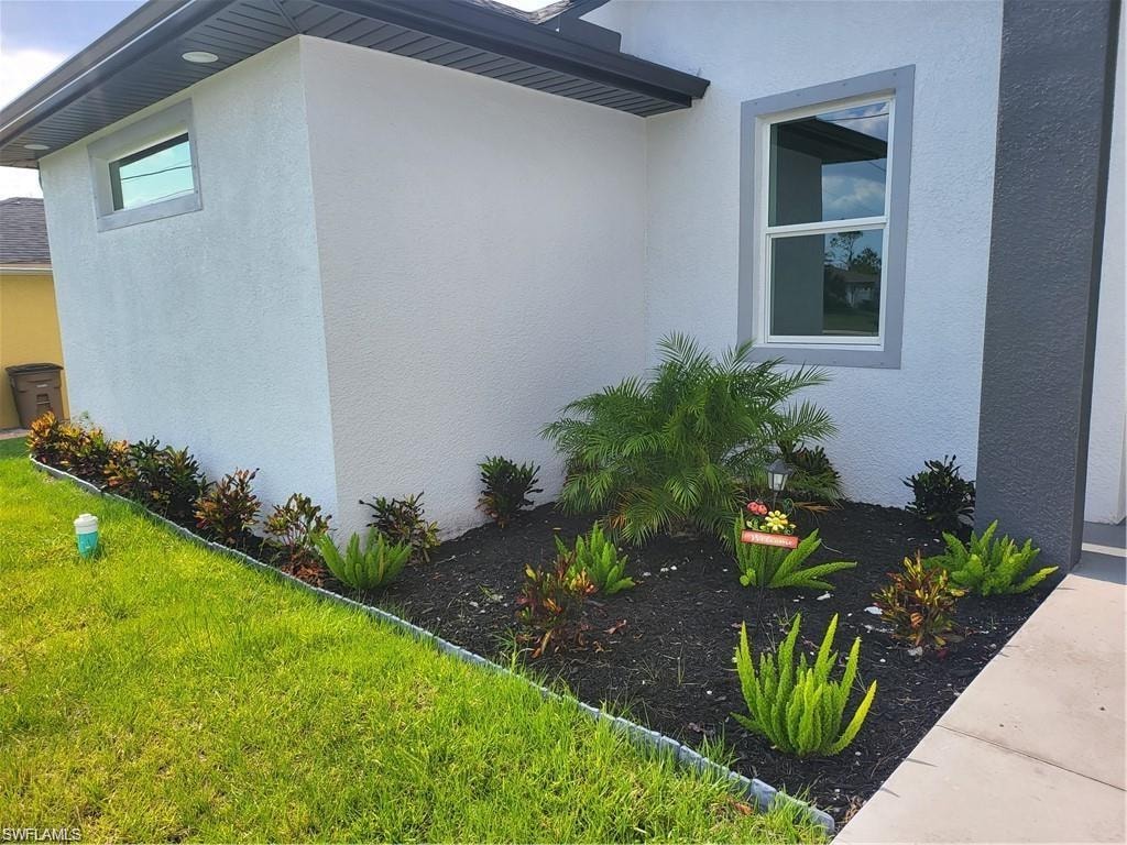 View of property exterior with a lawn