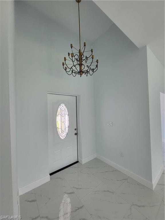 Entrance foyer featuring a notable chandelier
