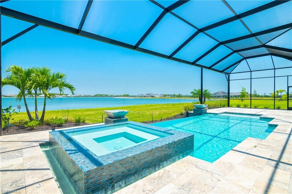 View of pool with a patio, an in ground hot tub, a water view, and glass enclosure