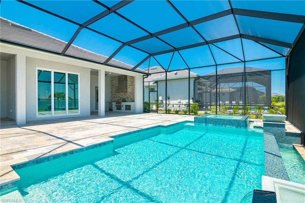 View of swimming pool with a lanai and a patio area