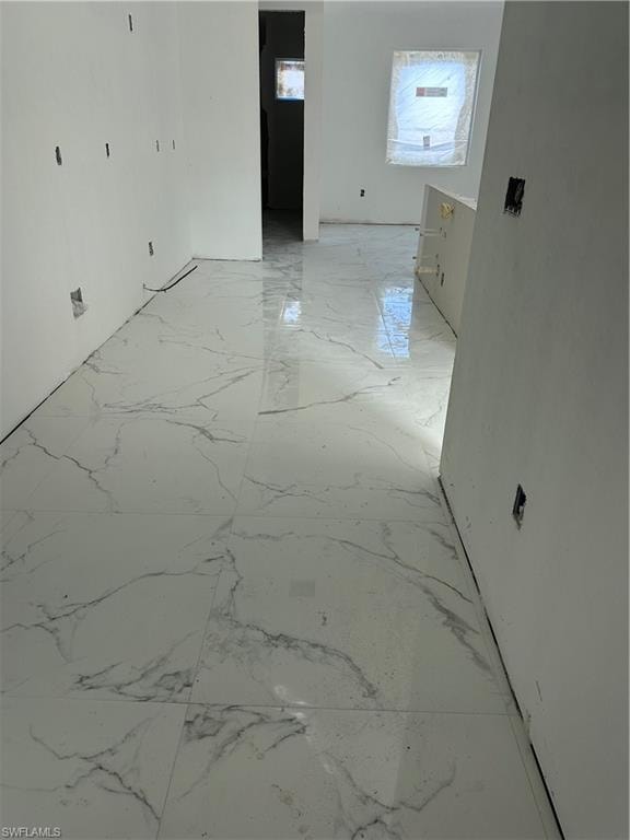 Spare room with light marble finish floors