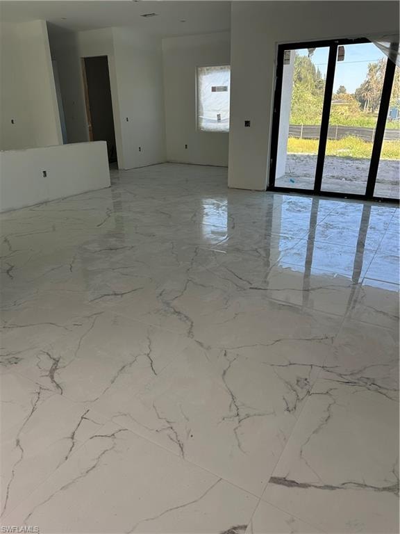 Unfurnished room with light marble finish flooring