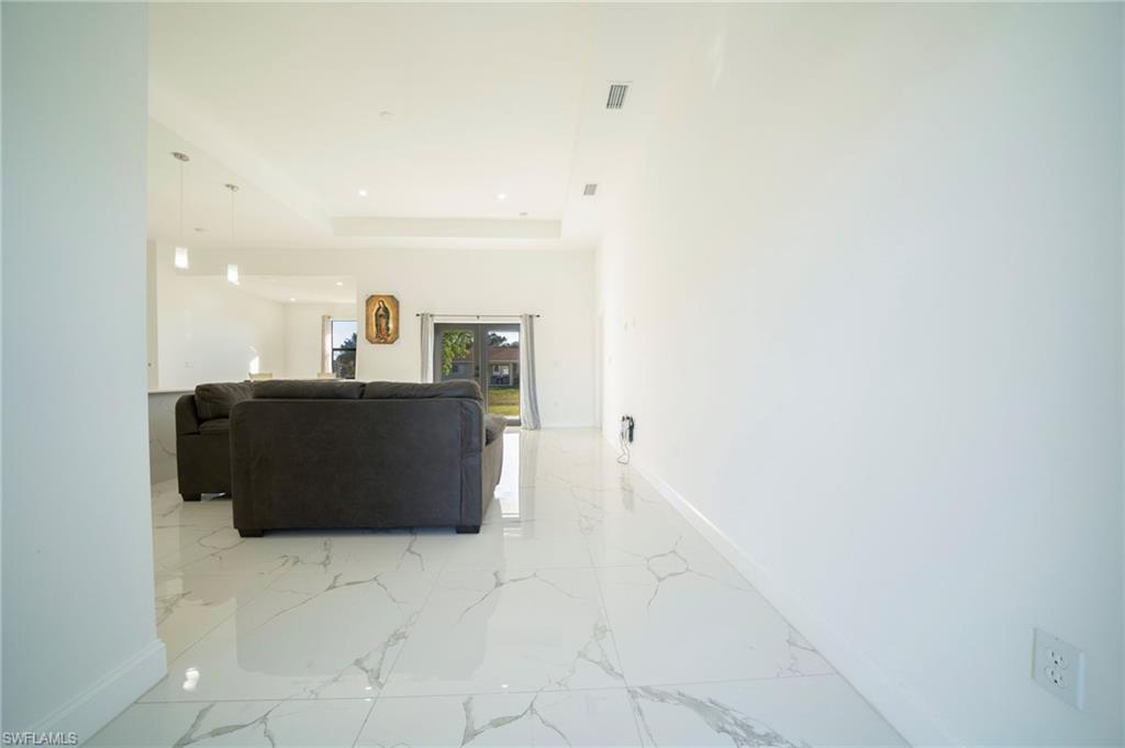 Living room featuring a tray ceiling