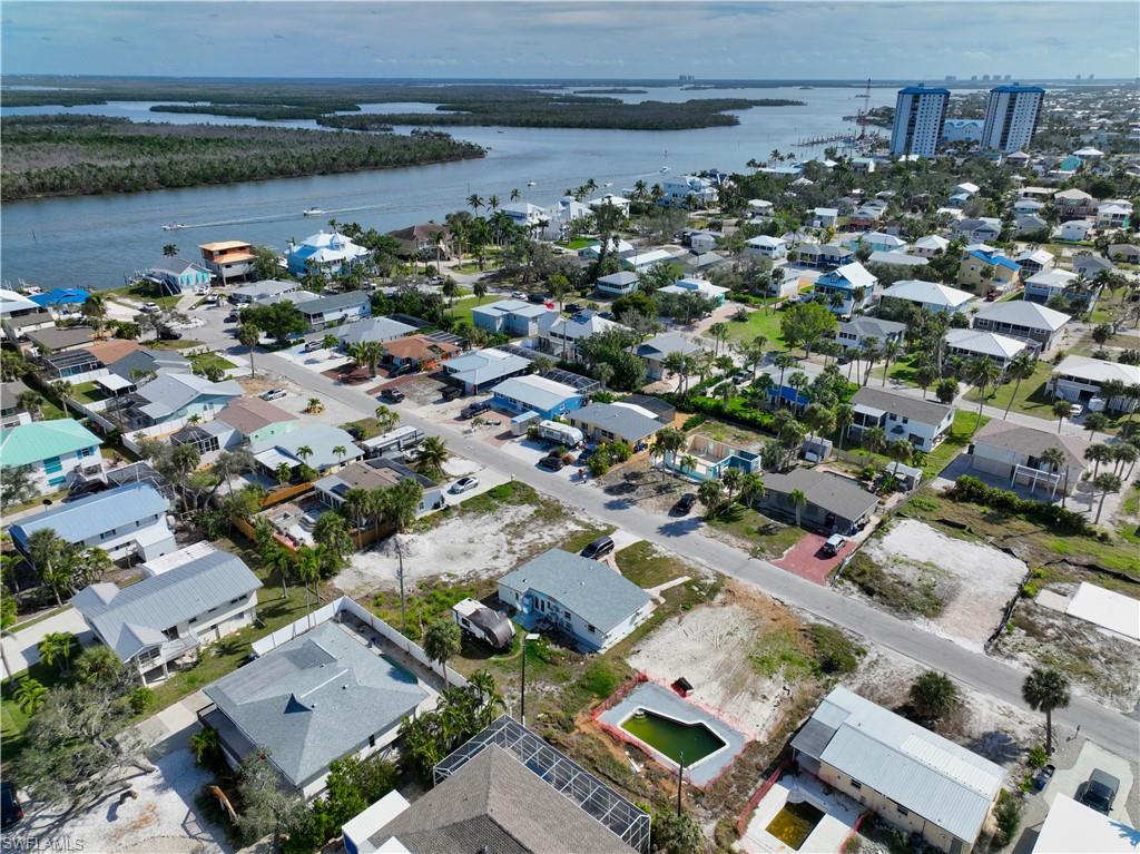 Birds eye view of property with a water view