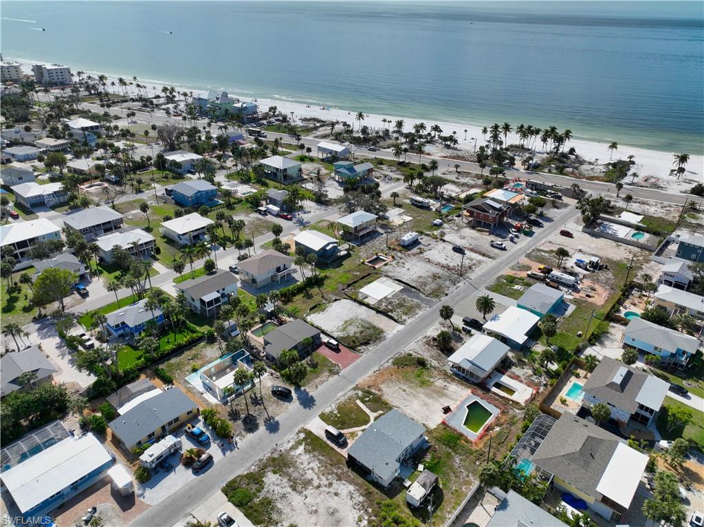 Aerial view featuring a view of the beach and a water view