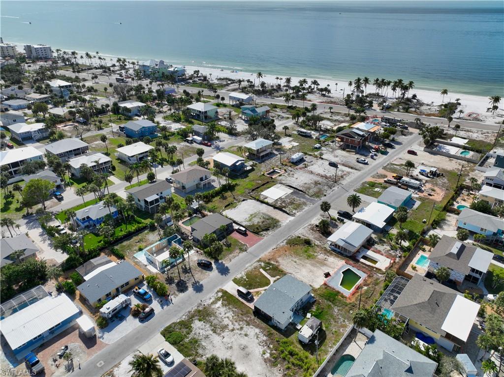 Drone / aerial view with a water view and a beach view
