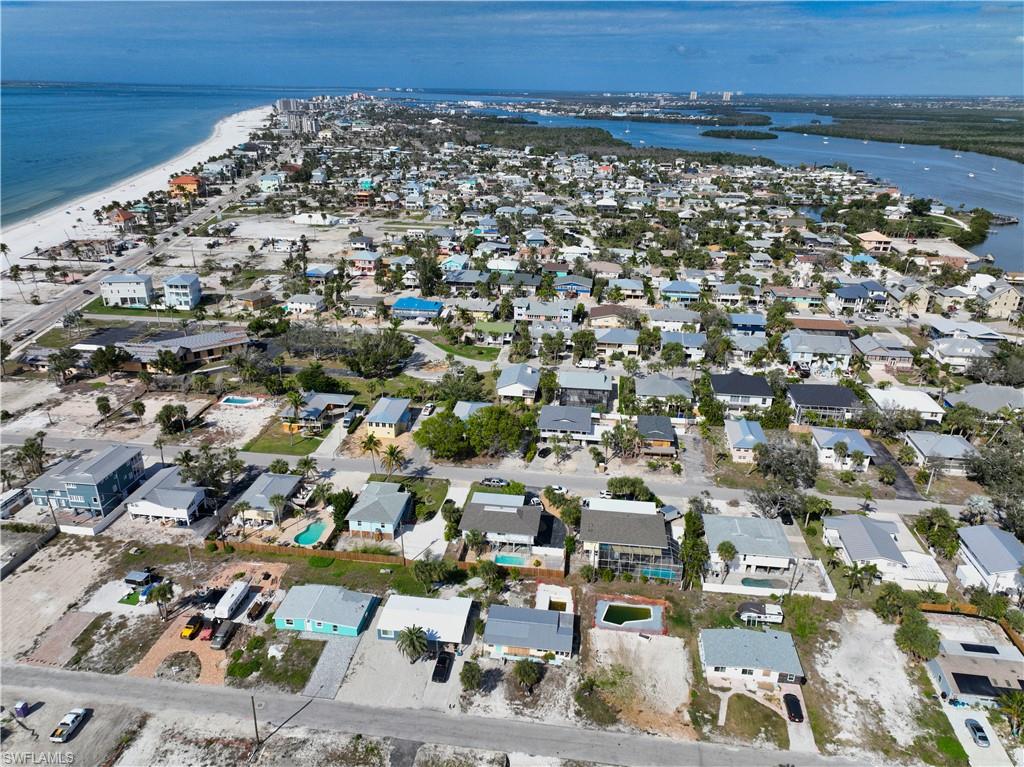 Drone / aerial view with a water view and a beach view