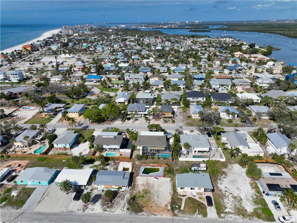 Birds eye view of property with a water view