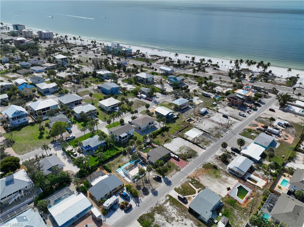 Birds eye view of property with a water view