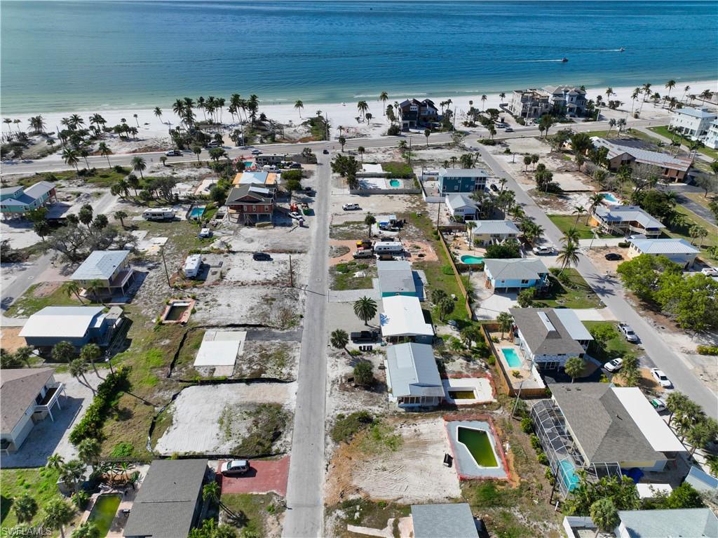 Aerial view with a water view and a beach view