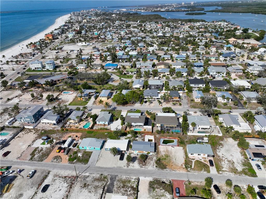 Birds eye view of property featuring a beach view and a water view