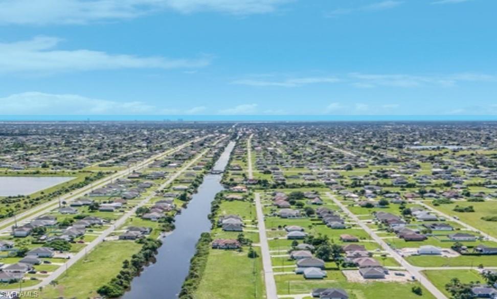 Drone / aerial view with a water view and a residential view