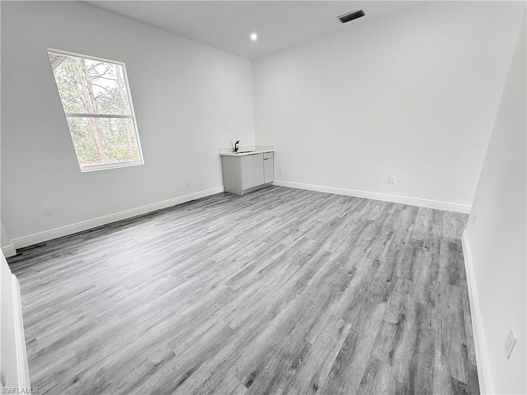 Unfurnished room with light hardwood / wood-style floors