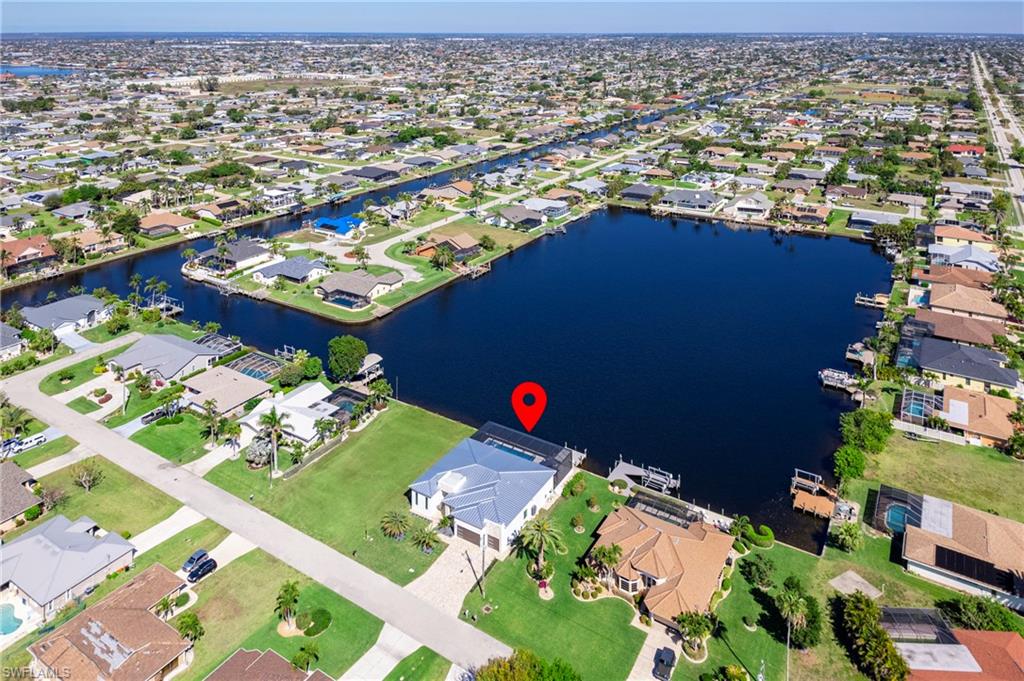 Birds eye view of property with a residential view and a water view