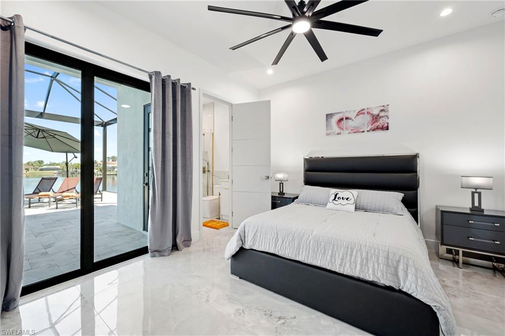 Bedroom with access to exterior, recessed lighting, ensuite bathroom, marble finish floor, and a ceiling fan