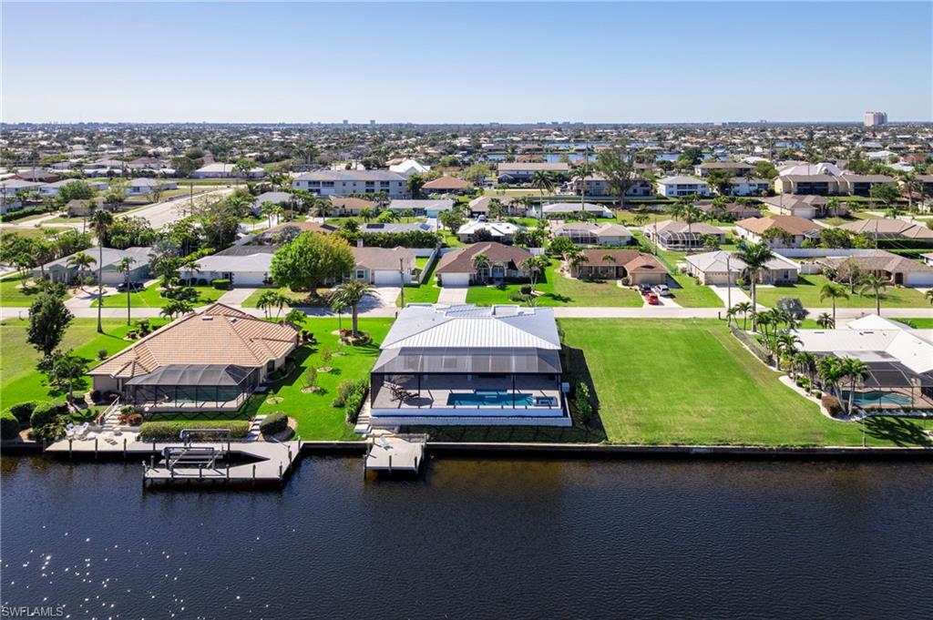 Birds eye view of property featuring a residential view and a water view