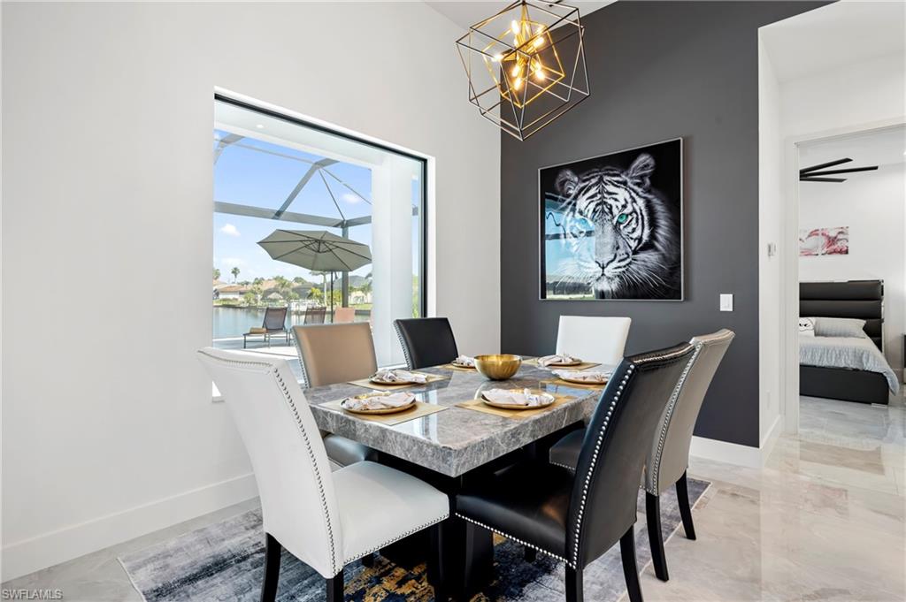 Dining room featuring baseboards and a chandelier