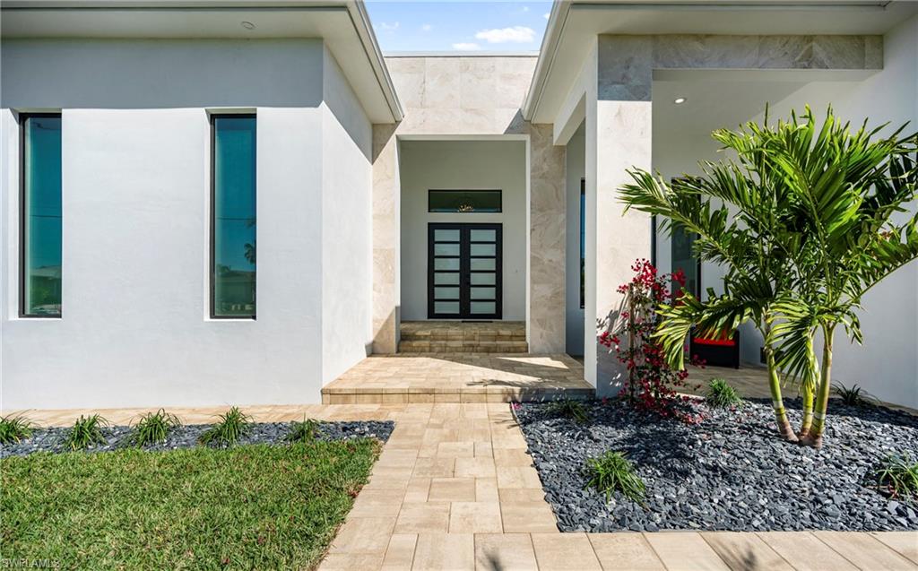 Property entrance featuring french doors and stucco siding