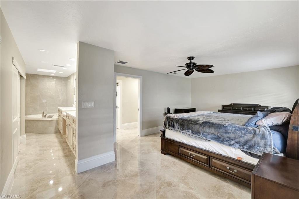 Bedroom with ensuite bathroom and ceiling fan