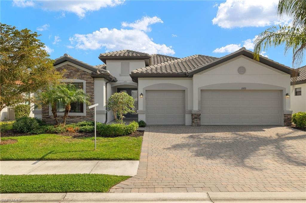 Mediterranean / spanish-style home featuring a front yard and a garage