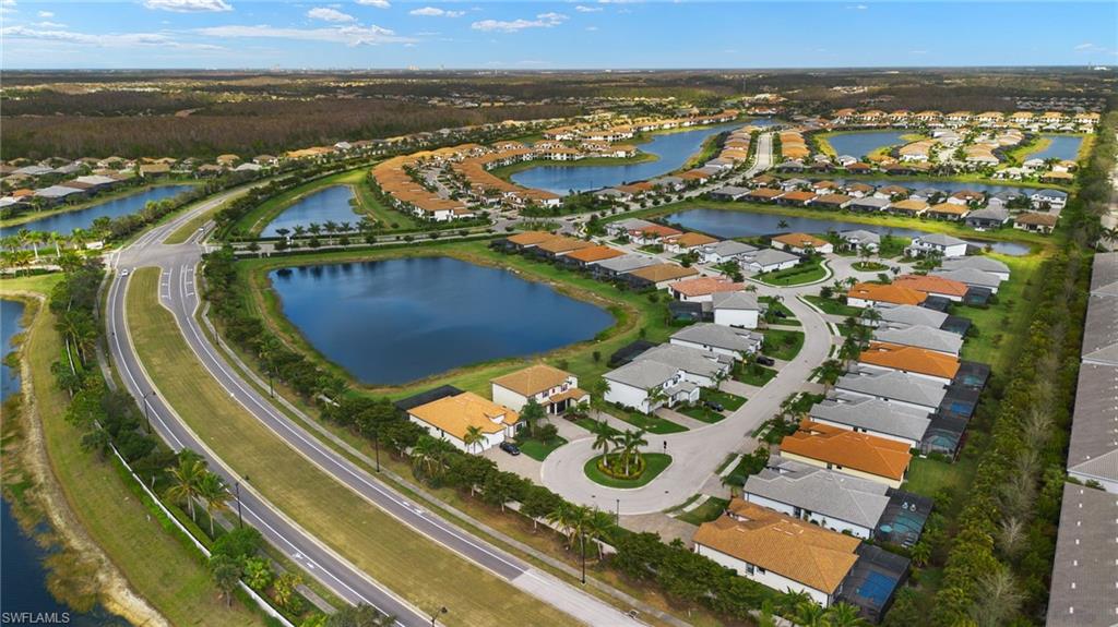 Birds eye view of property with a water view