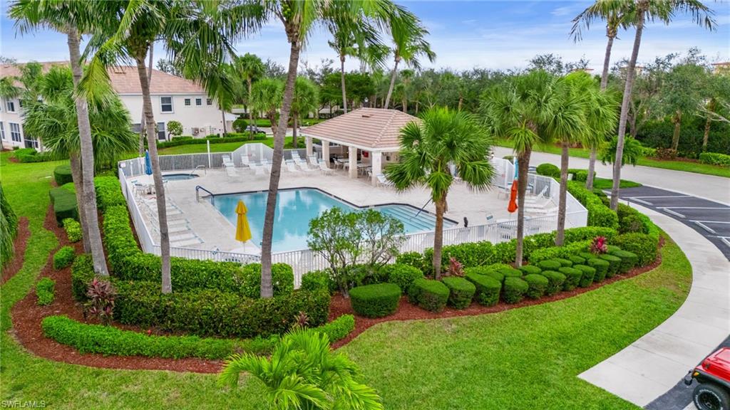 Pool featuring a patio, a lawn, and fence