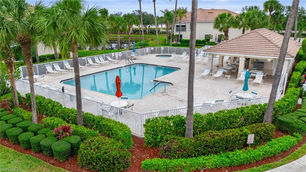 Community pool featuring a patio area, fence, and a gazebo