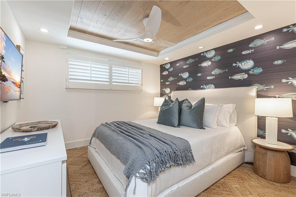 Bedroom with baseboards, a raised ceiling, wood ceiling, and recessed lighting