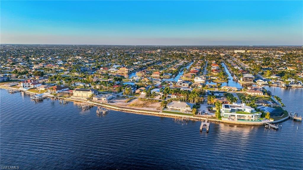 Birds eye view of property with a water view
