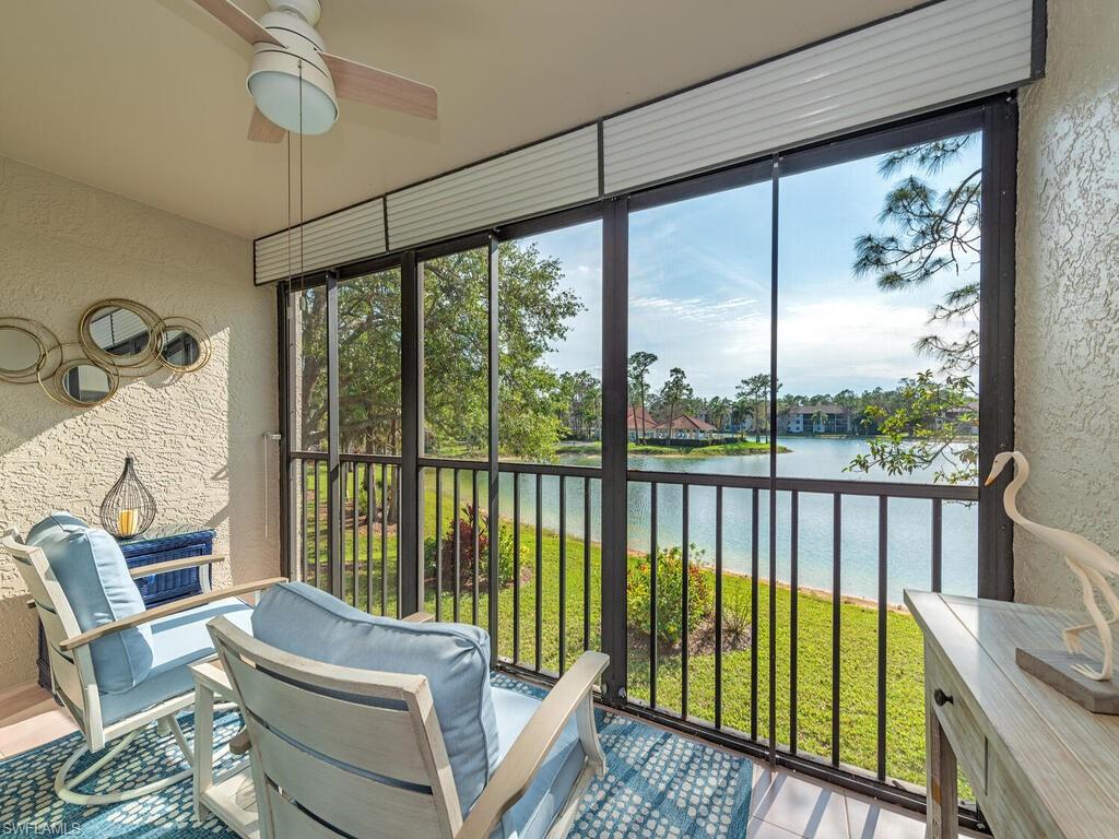 Sunroom / solarium featuring a water view and a ceiling fan