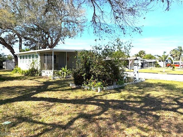 View of yard featuring a sunroom