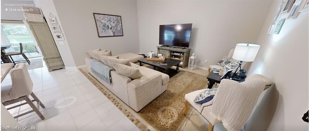 Living area featuring light tile patterned floors and baseboards