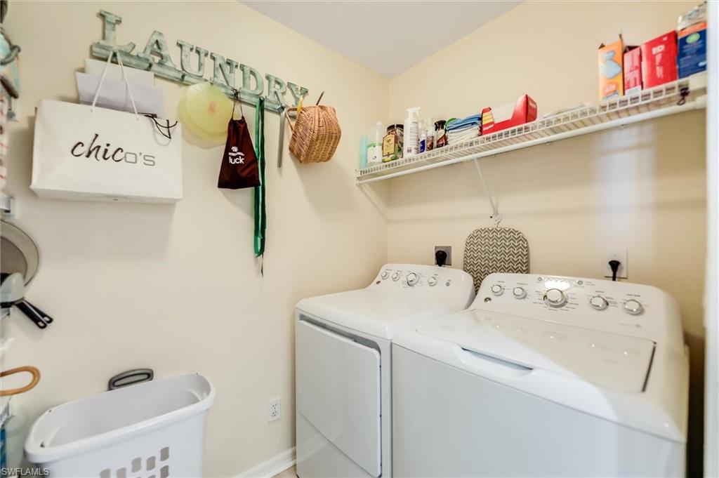 Laundry area featuring laundry area, separate washer and dryer, and baseboards