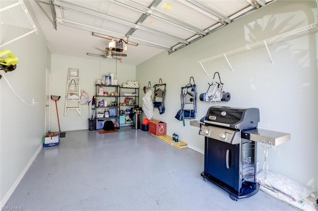 Garage with a garage door opener and baseboards
