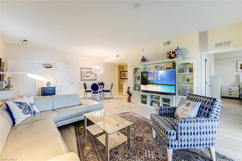 Living area with light wood-style flooring and visible vents