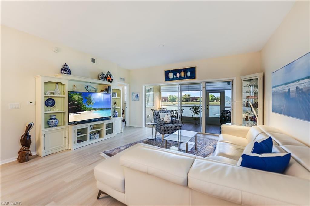Living area featuring light wood-type flooring, visible vents, and baseboards
