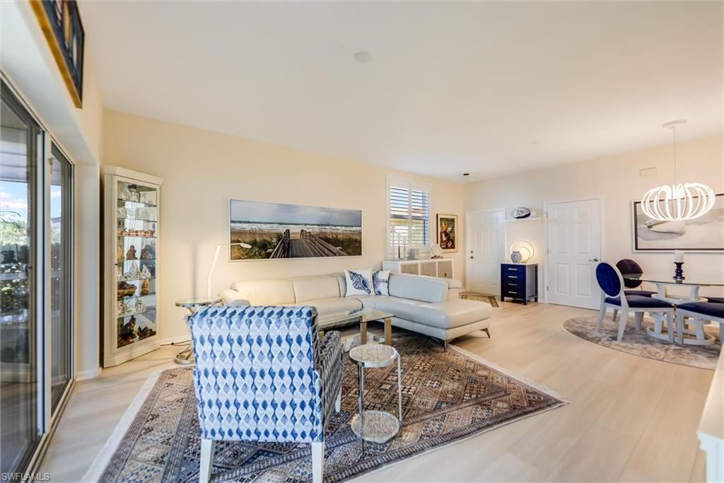 Living room featuring an inviting chandelier and wood finished floors