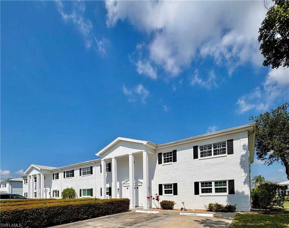 View of front of property featuring uncovered parking and brick siding